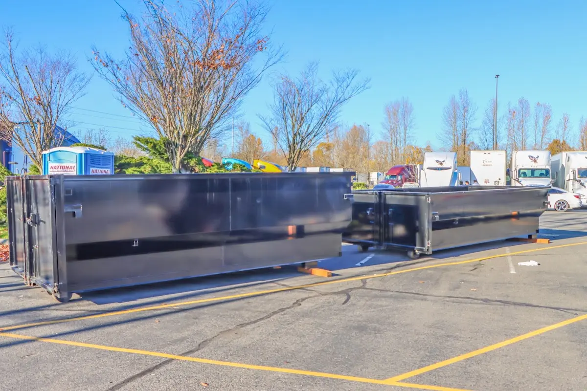 Professional dumpster rental service with roll-off container on residential driveway in Eldridge